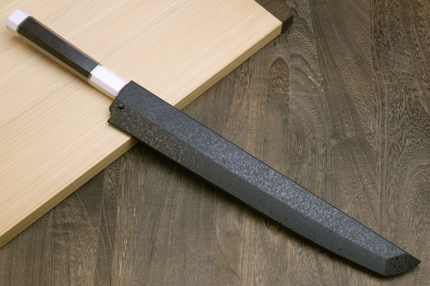 Japanese sushi sashimi knife with dark grey blade and ebony handle with silver ring