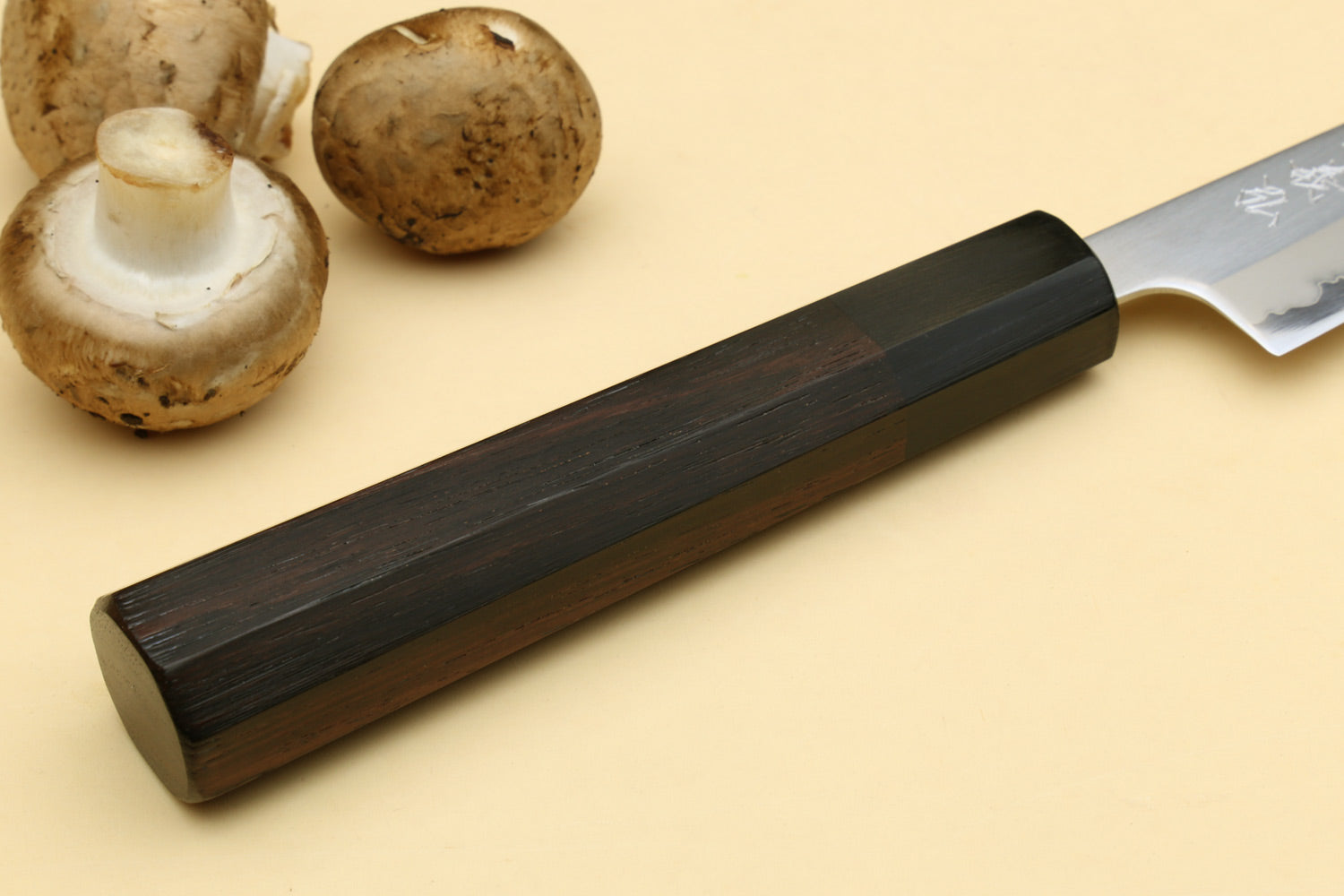 Petty utility knife with dark rosewood handle and silver blade, angled view