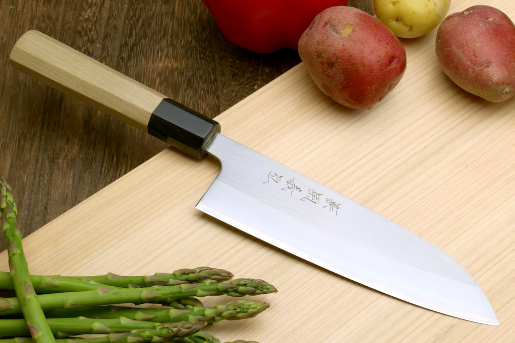 Stainless santoku knife with magnolia wood handle, dark bolster, and etched blade
