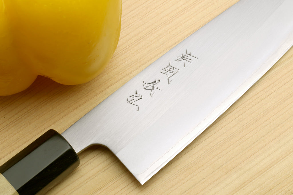 White stainless santoku knife with magnolia wood handle, engraved blade