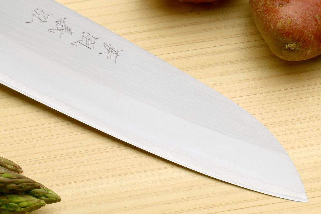 White stainless santoku knife blade tip with etched characters and dark bolster