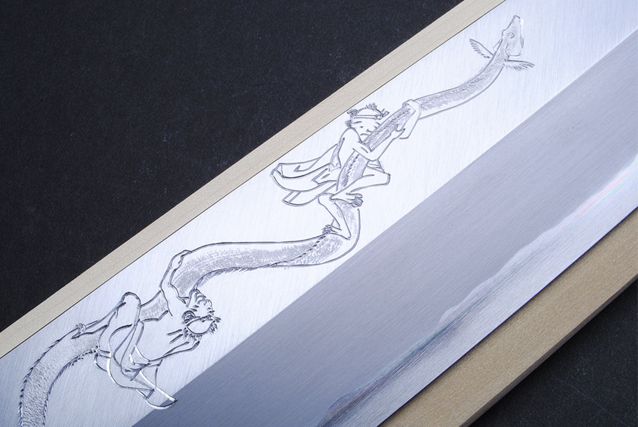 Japanese eel bone slicer knife, close view of engraved blade artwork.