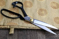 Right-handed fabric scissors with dark handles, silver blades, and gold pivot