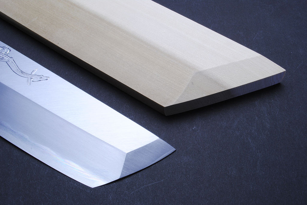 Japanese eel bone slicer knife, close-up of polished blade edges and engraving.