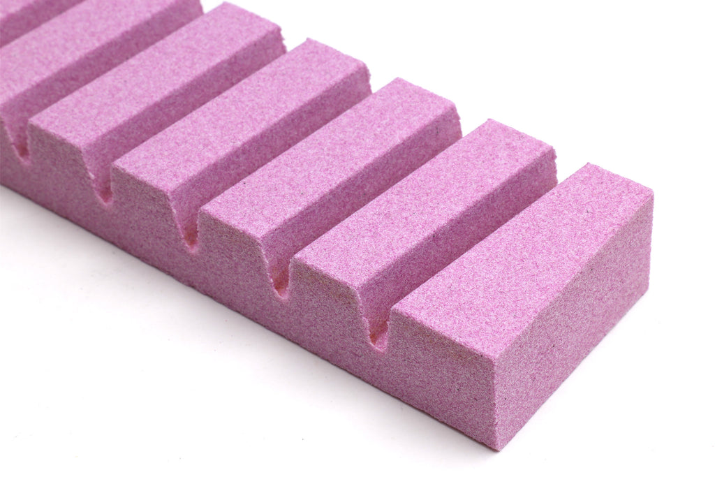 Stone fixer close-up of rectangular purple blocks with slots.