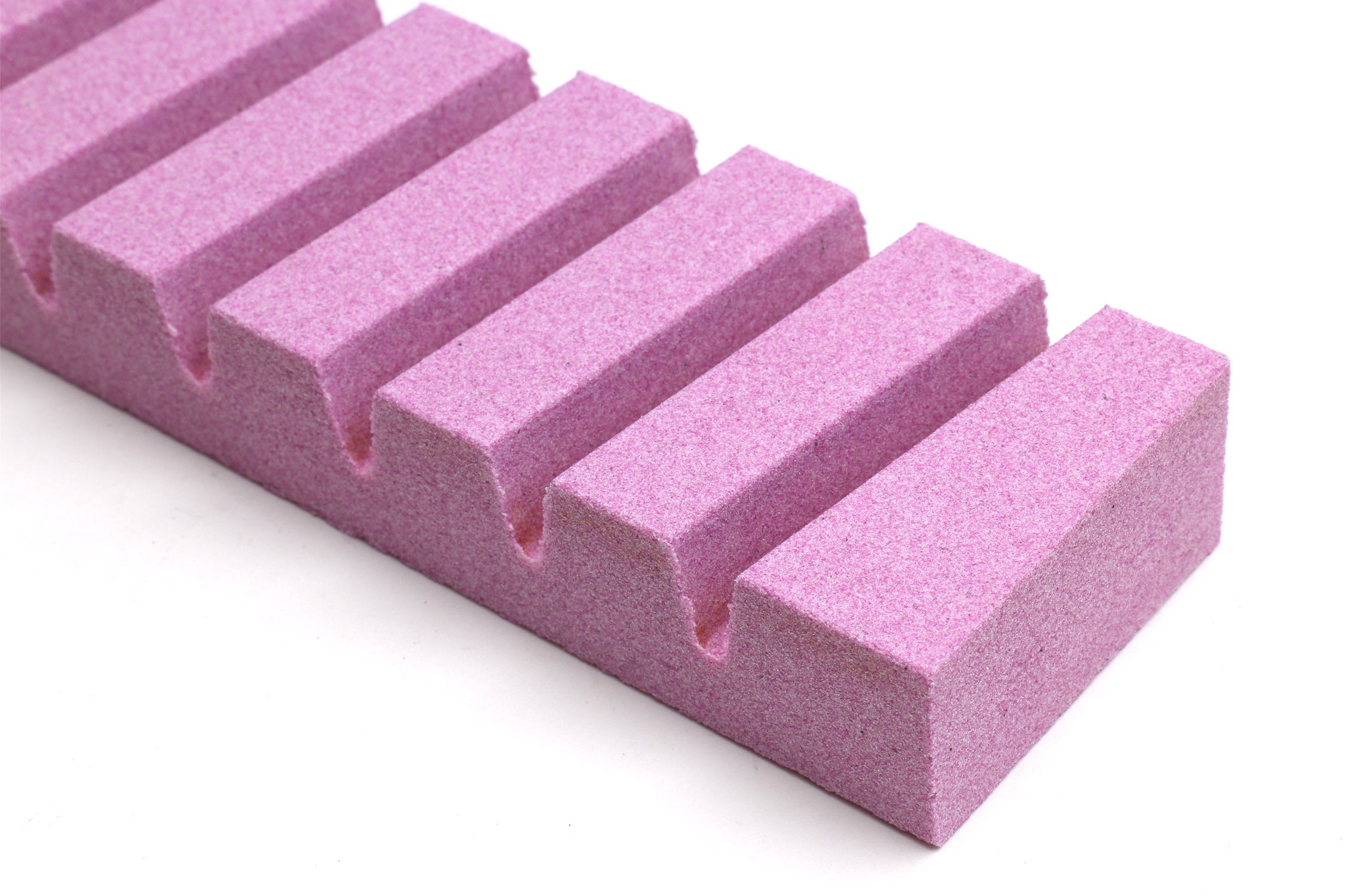 Stone fixer close-up of rectangular purple blocks with slots.