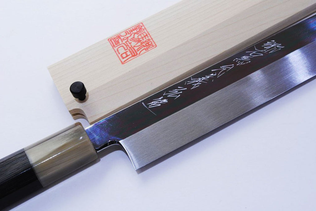 Kiritsuke sushi knife with engraved blade markings, dark ferrule, and wood handle