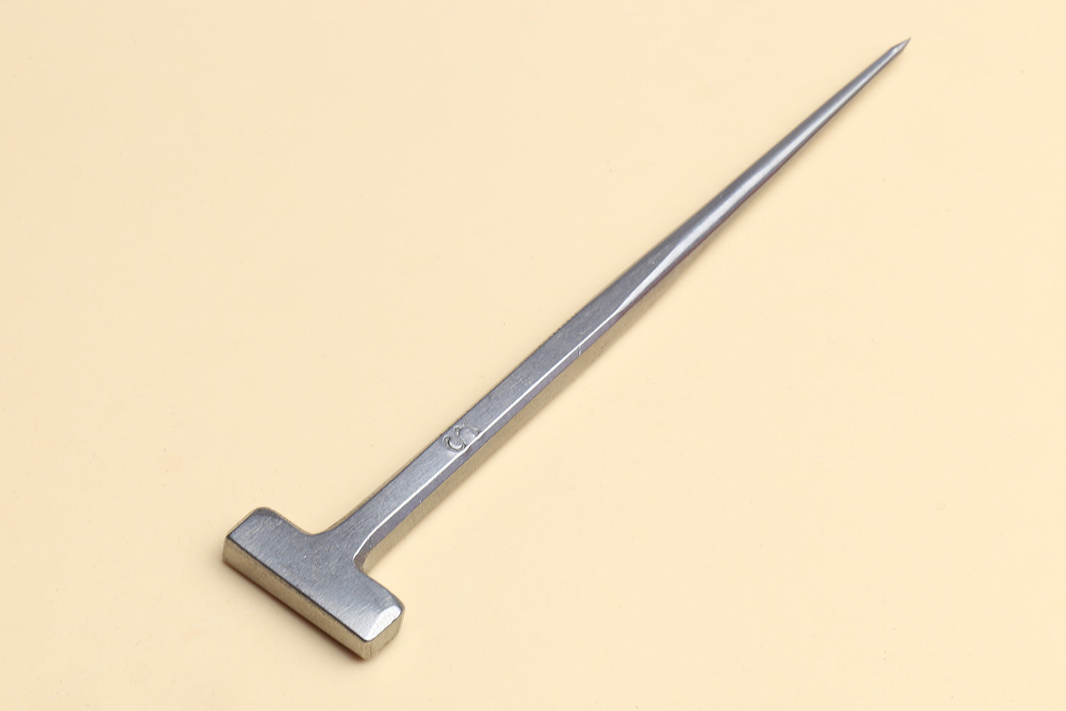 Metal T-shaped eel spike tool with a long pointed tip