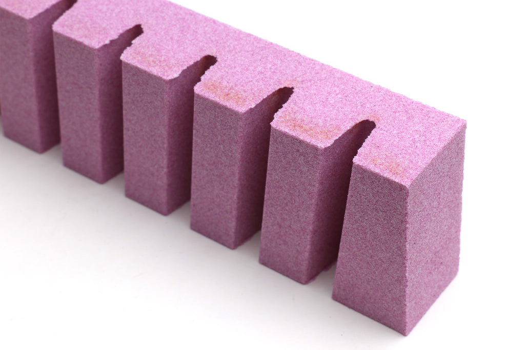 Stone fixer with top view of rectangular purple blocks and notches.