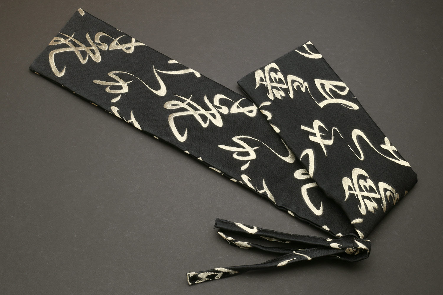 Japanese knife pouch bag in black with gold kanji pattern and knotted tie