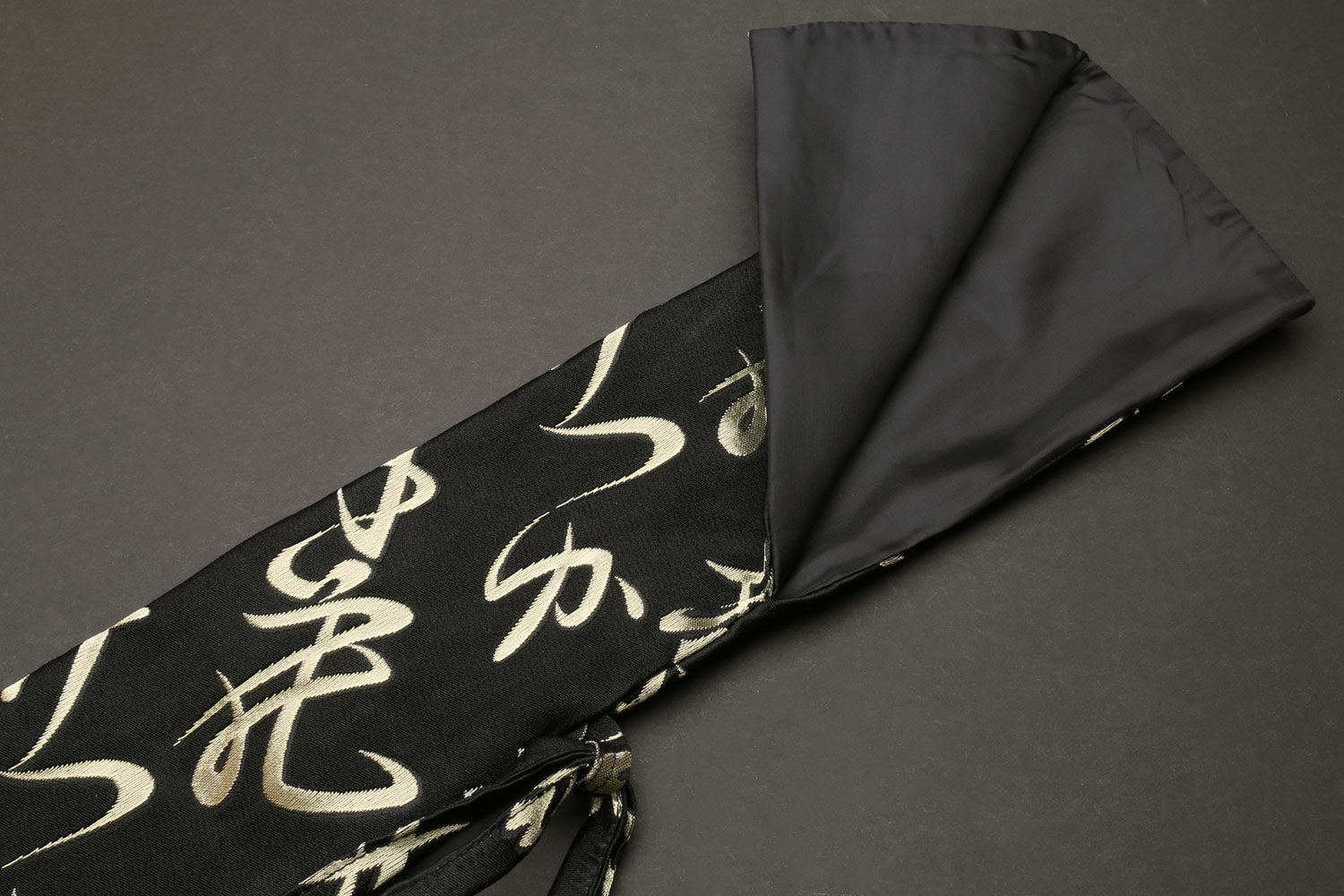 Japanese knife pouch bag, black exterior with gold kanji; gray interior lining visible