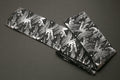 Knife pouch bag with black fabric and white Japanese wave pattern, folded with dark strap