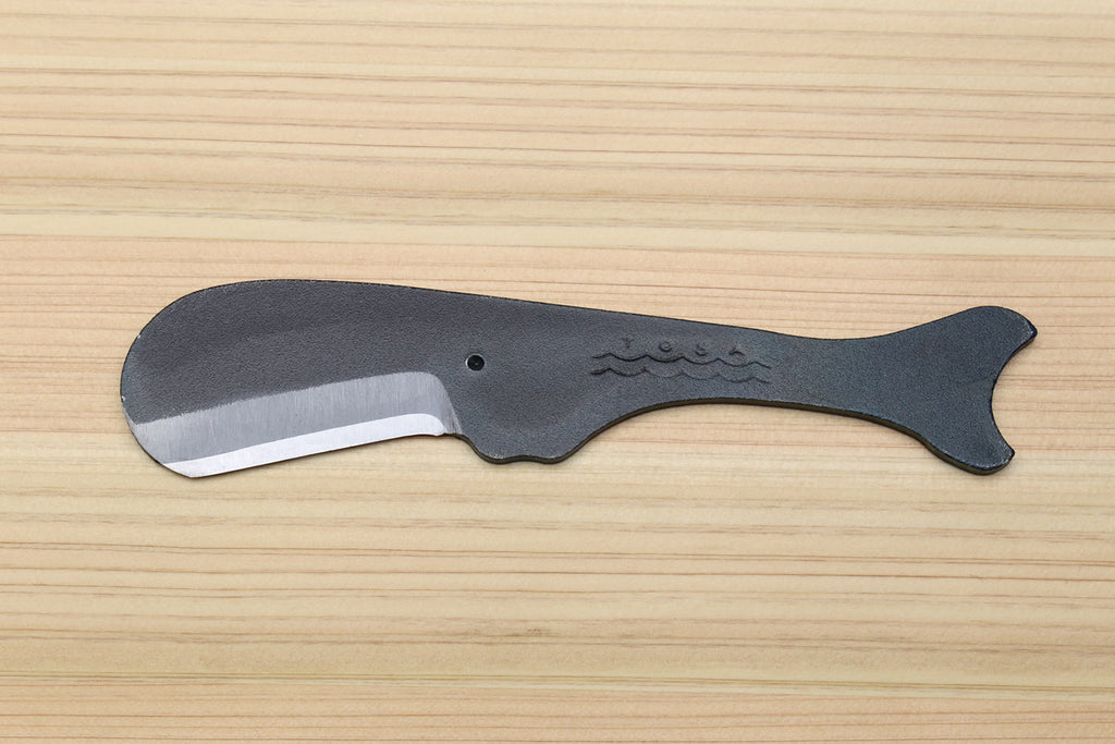 Utility knife with dark kurouchi finish, whale pattern, and curved silver blade