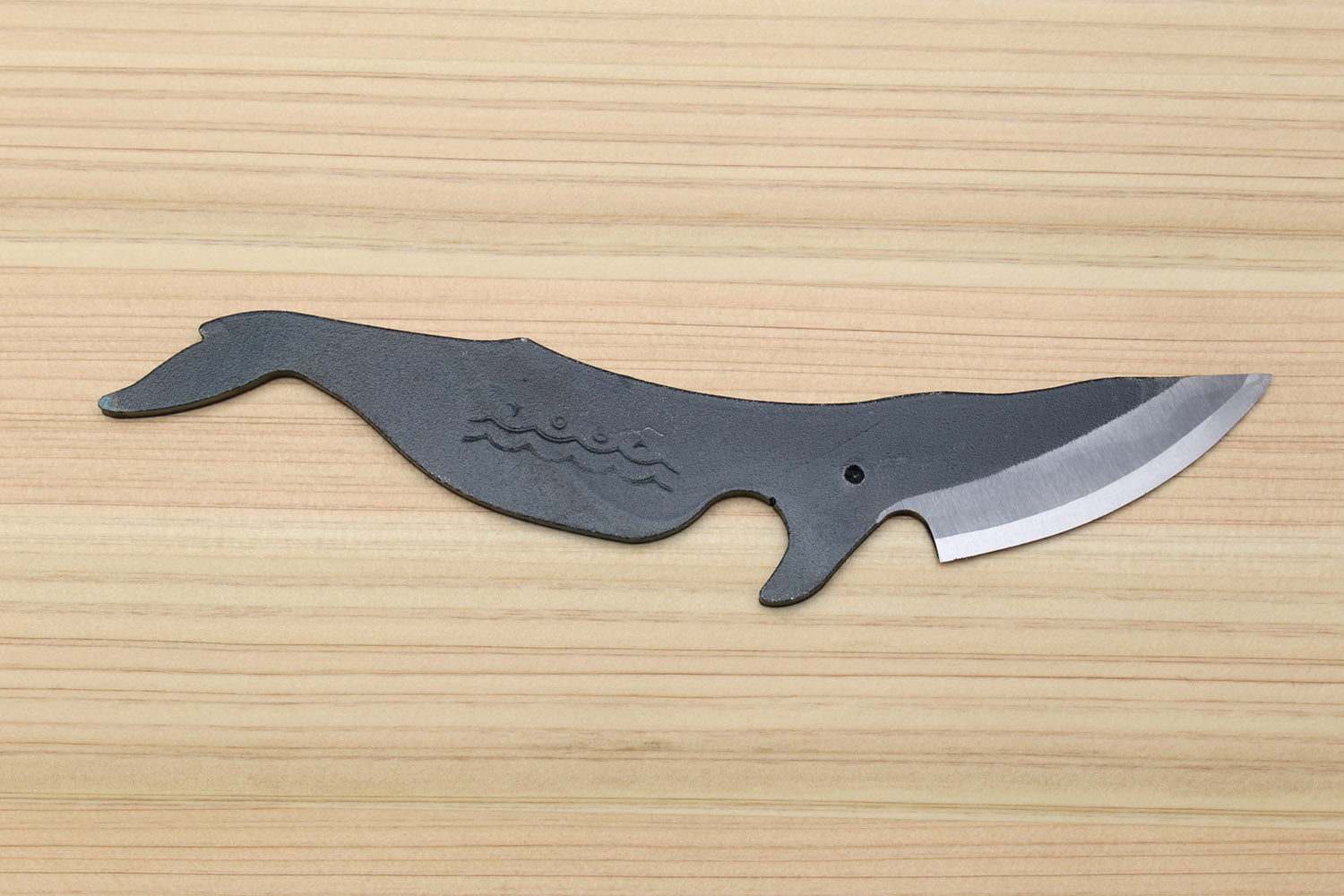 Whale utility knife with blue-gray handle and curved stainless blade, side view