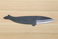 Japanese utility knife with dark handle, wave-engraved bolster, and silver edge