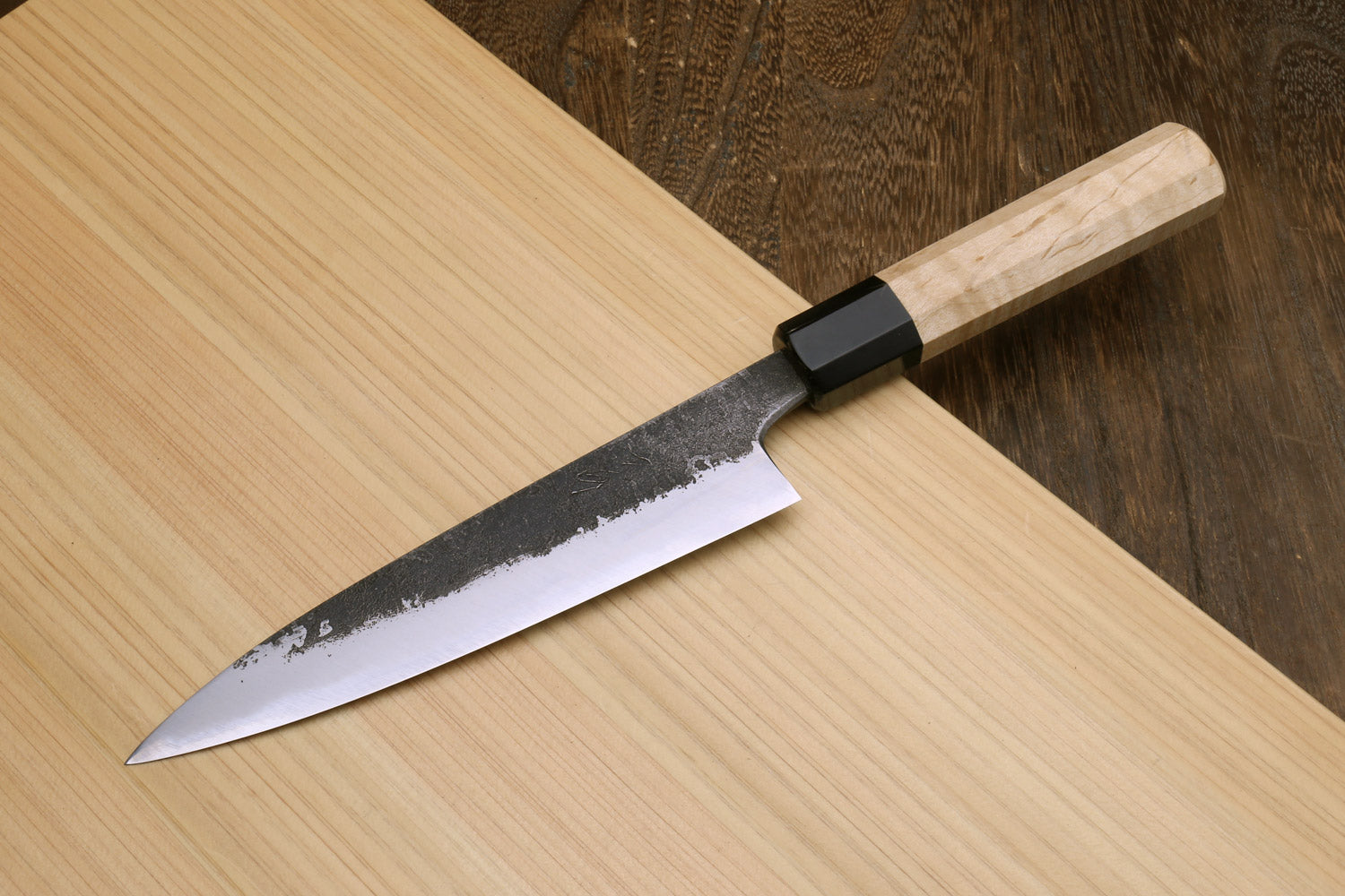 Petty utility knife with dark speckled blade, black bolster, and light camphor handle