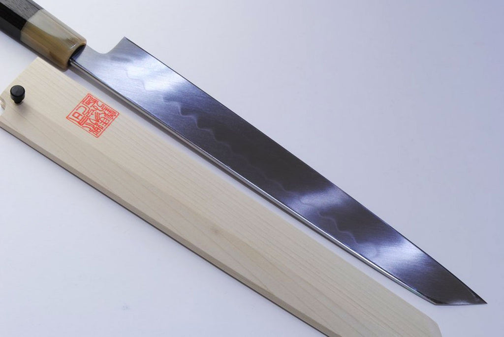 Kiritsuke sushi knife close-up of mirror-finished steel blade and wood handle