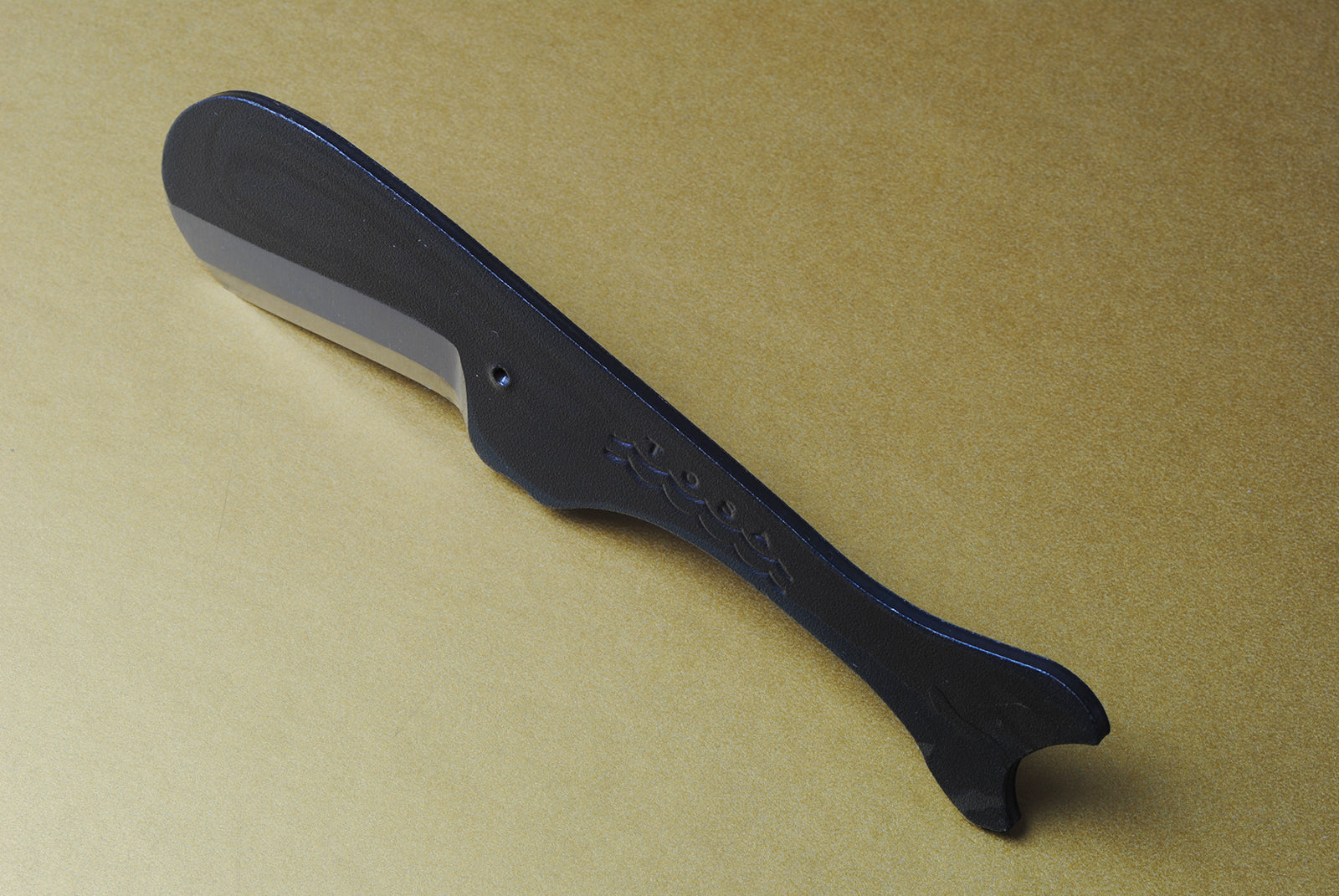 Utility knife back view with dark kurouchi handle and stamped logo on blade spine