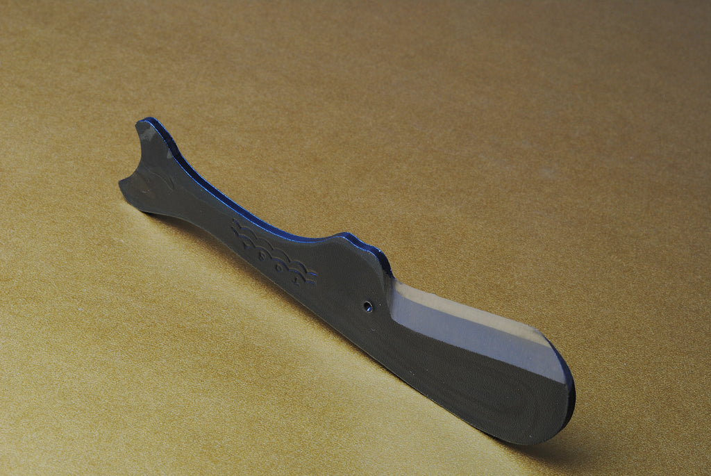 Utility knife top view with dark kurouchi finish, whale-shaped handle and blade bevel