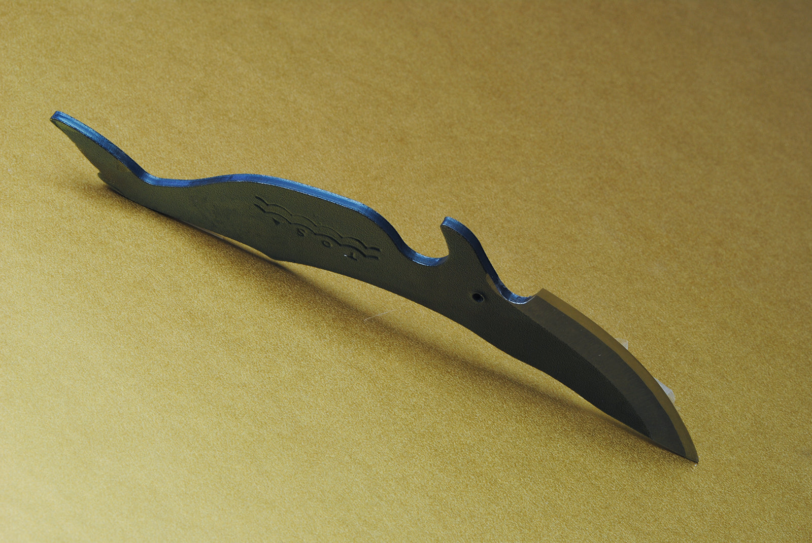 Whale-shaped utility knife with dark handle and curved black-finished blade