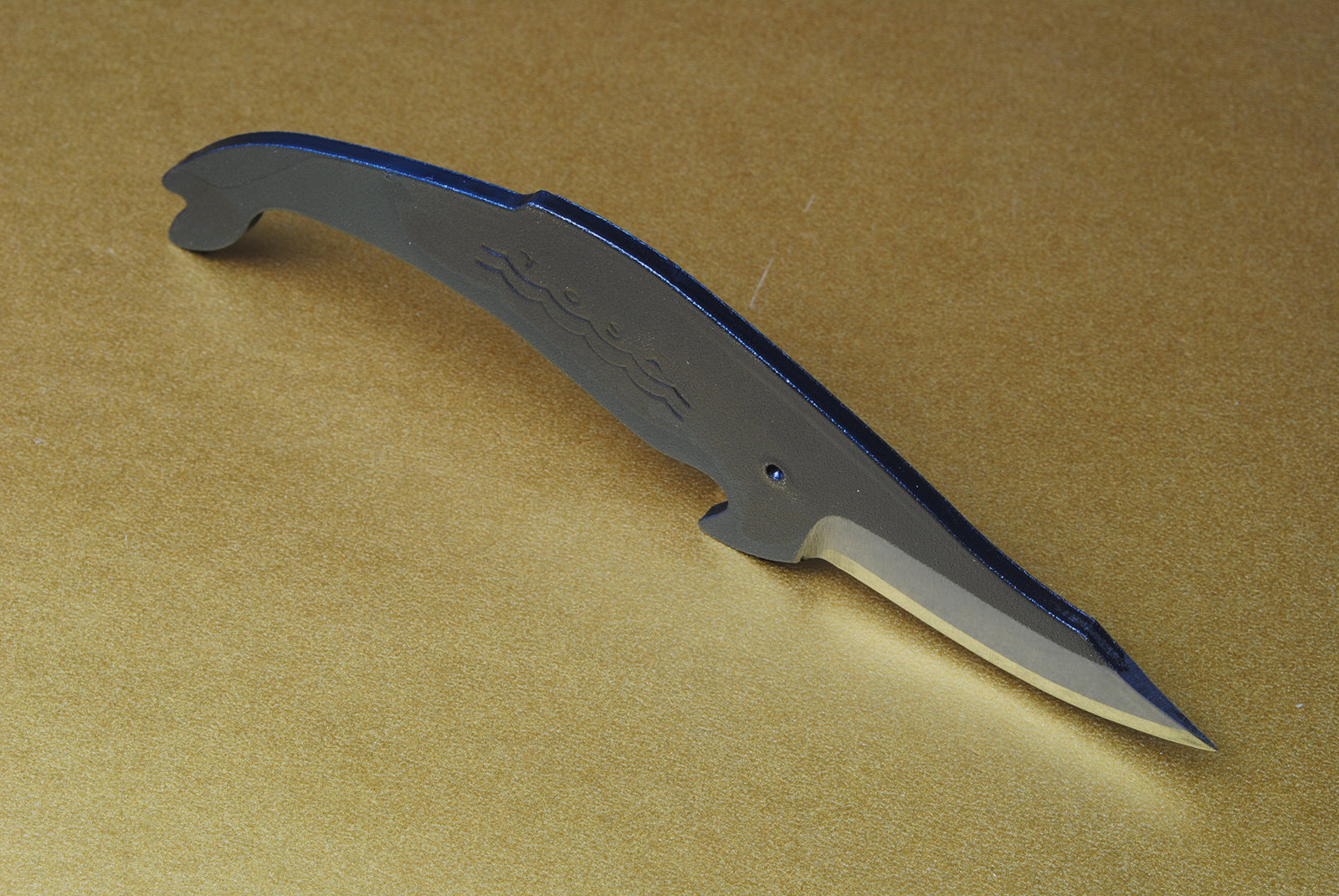 Whale utility knife with textured handle waves and short pointed silver blade