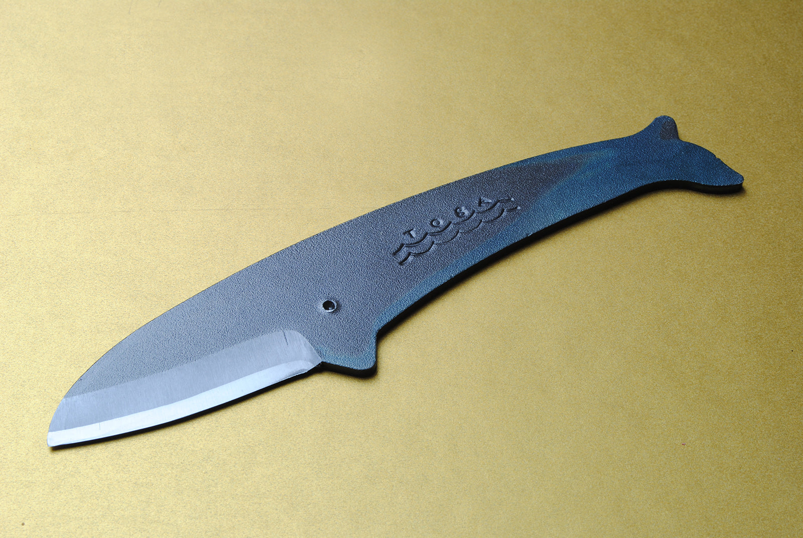 Whale utility knife with dark blue handle and silver blade, pointed tip
