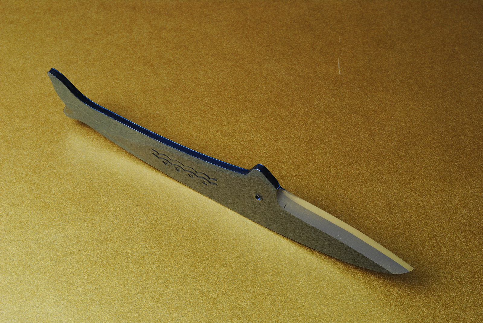 Japanese utility knife with dark blue whale handle and silver blade, etched side