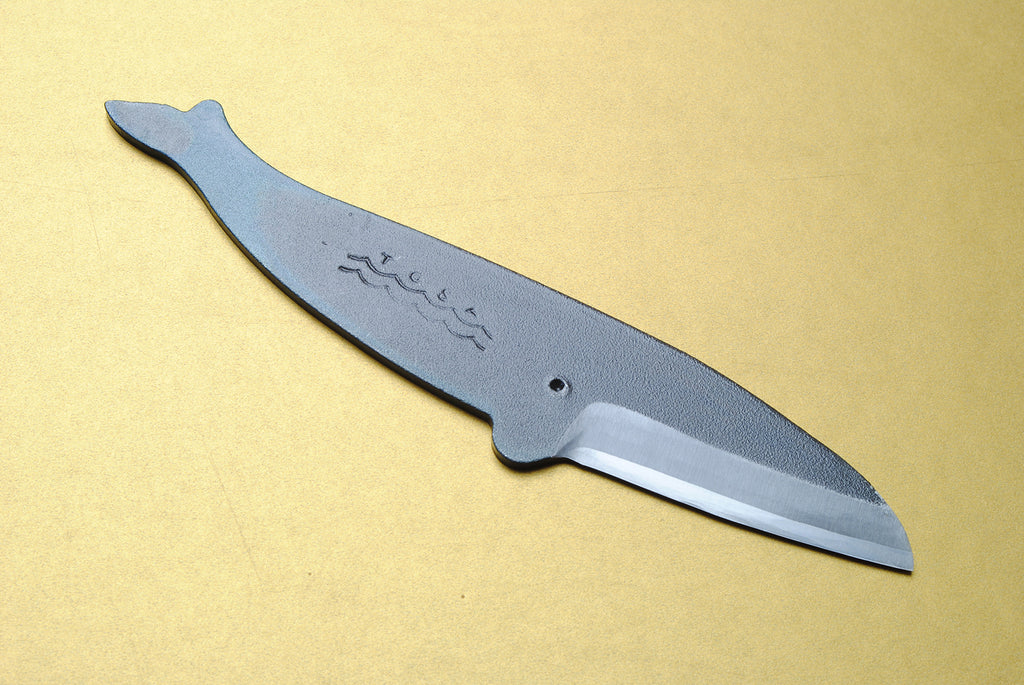 Japanese utility knife with dark kurouchi finish, wave engraving, and pointed blade