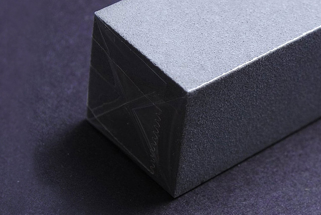 SABITORI rust eraser block, angled end view with textured dark sides