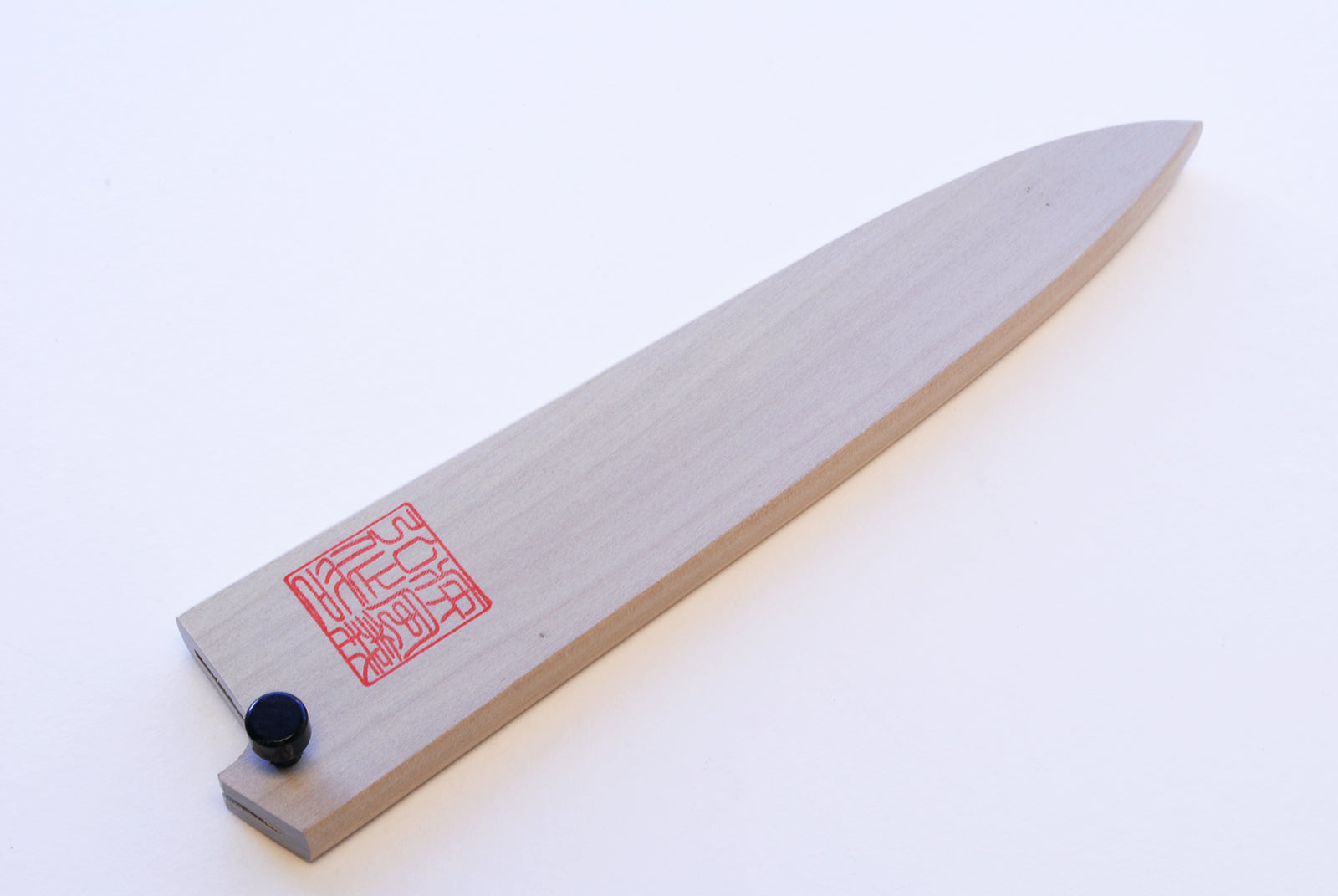Natural magnolia wood saya cover for petty knife, showing blade edge and stamp label.