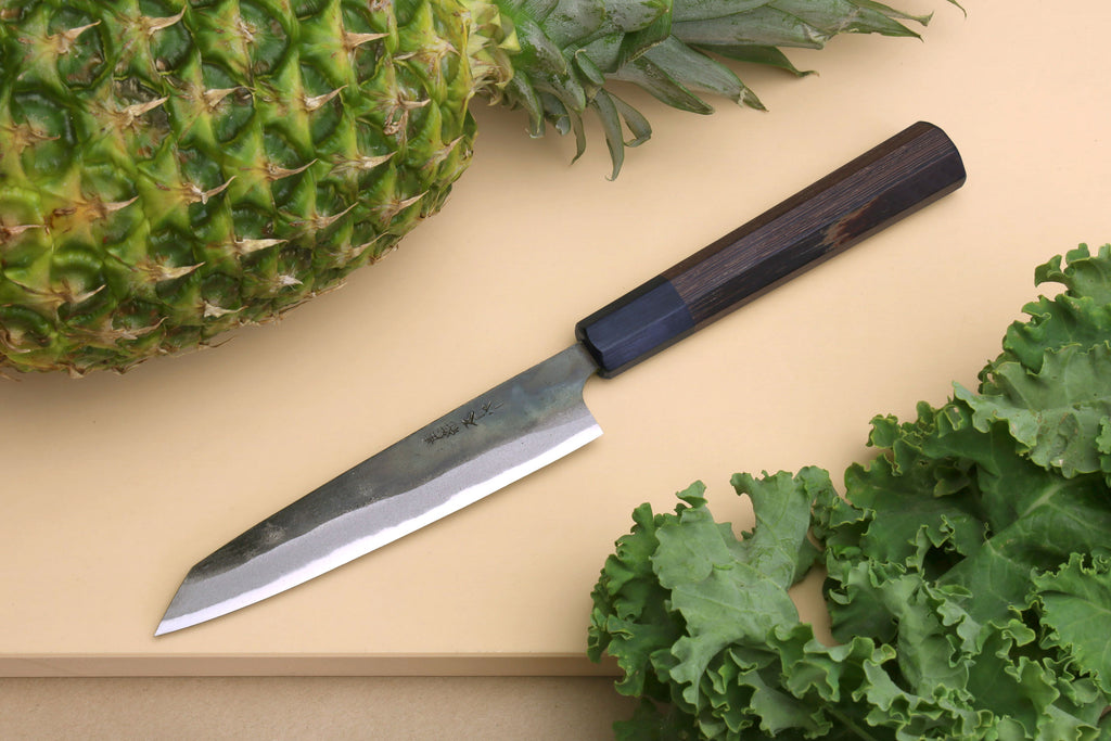 Petty utility knife with kurouchi-finished steel blade and dark shitan wood handle.