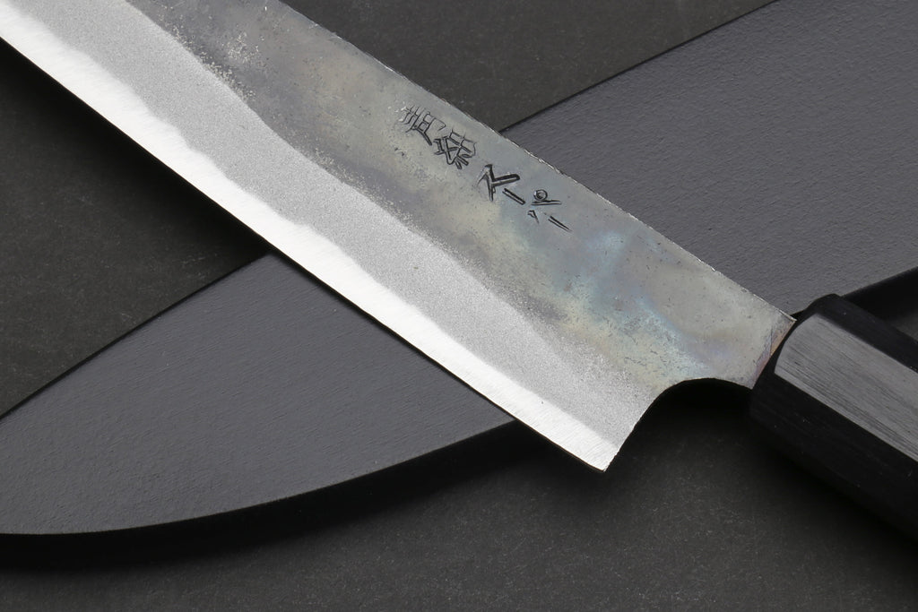 Petty utility knife blade with engraved text on darkened steel, dark shitan handle.