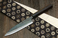 Petty utility knife with dark shitan wood handle and kurouchi finish blade
