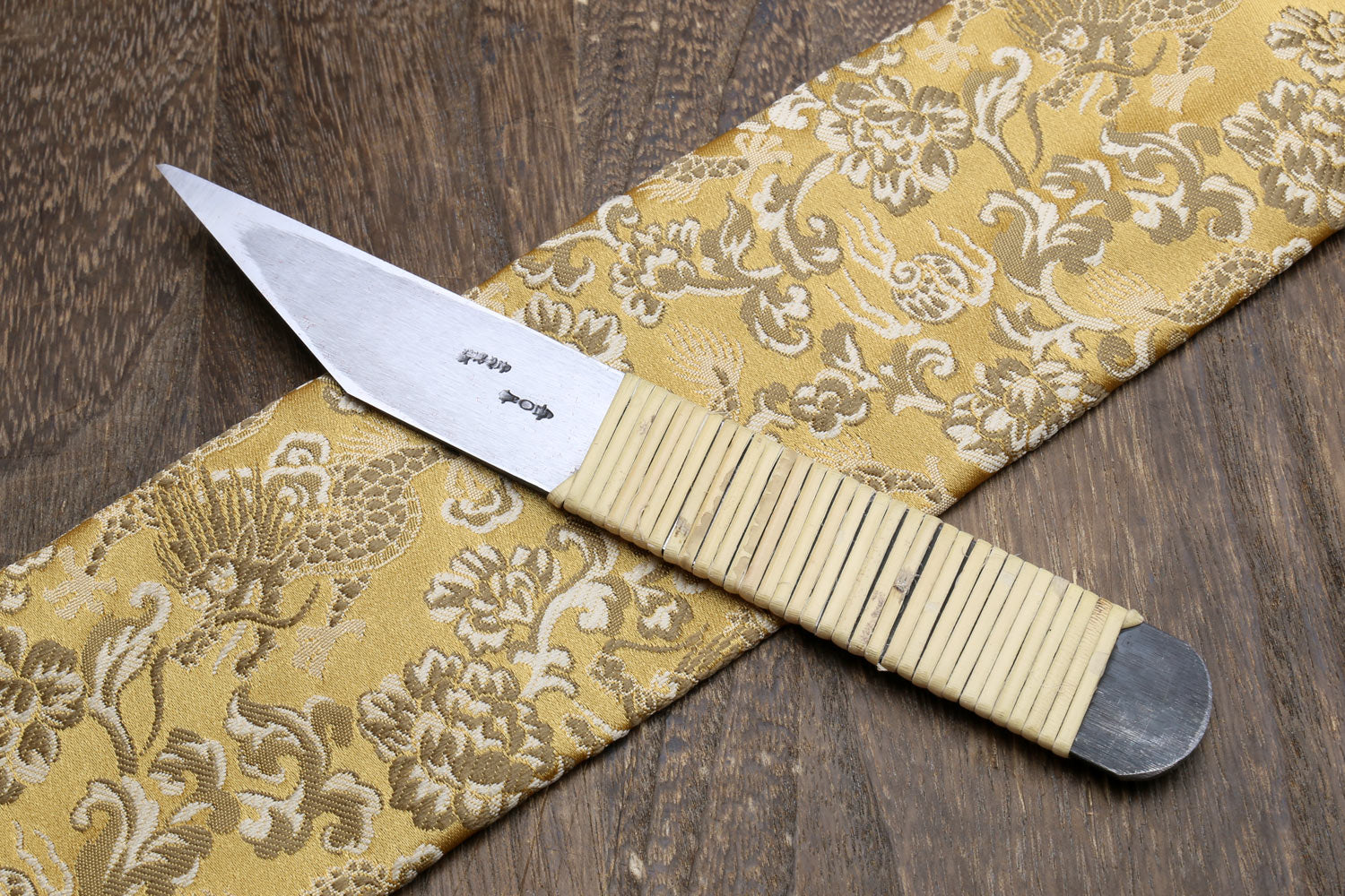 Kiridashi utility knife showing blade markings and ribbed light wooden handle