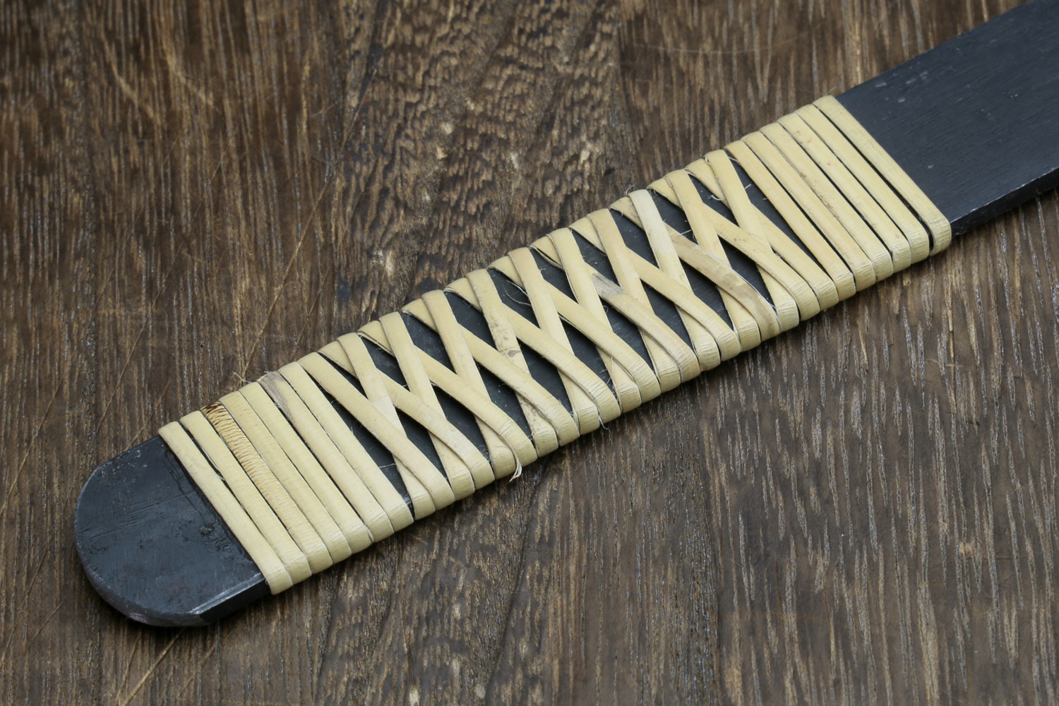 Kiridashi utility knife handle detail with light ribbed wood scales and dark end cap