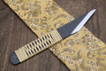 Kiridashi utility knife with ribbed wood handle and dark blade showing sharp tip