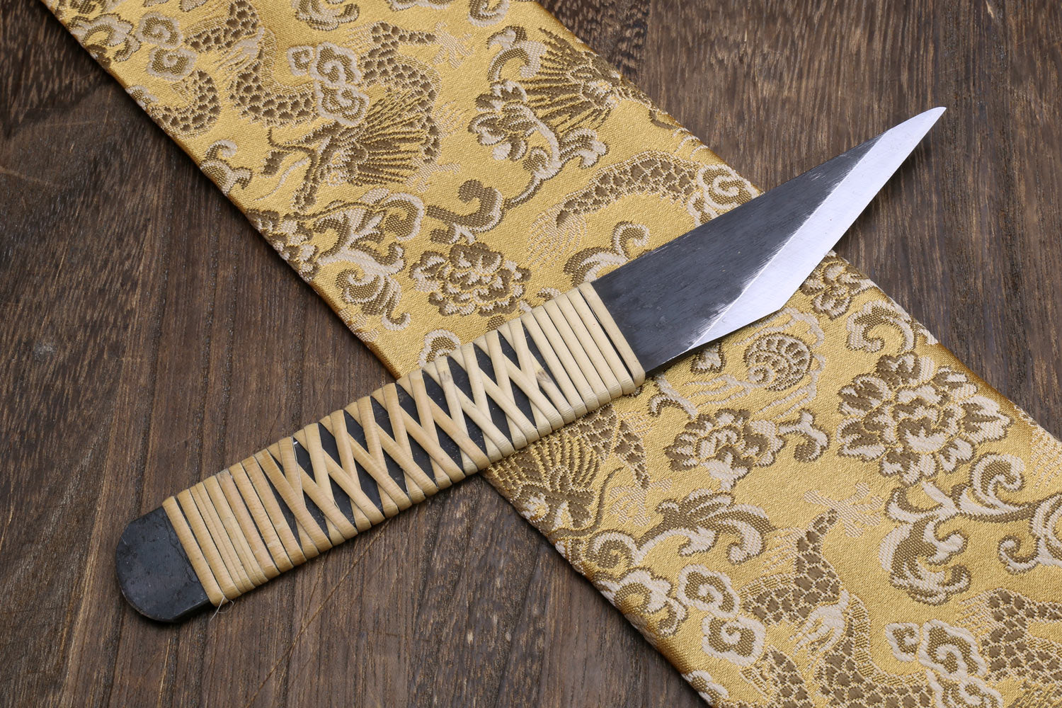 Kiridashi utility knife with light ribbed wooden handle and dark steel blade