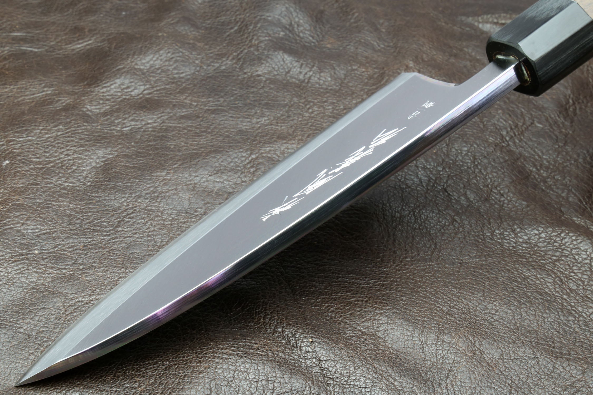 Japanese deba knife with polished white blade and dark shitan handle
