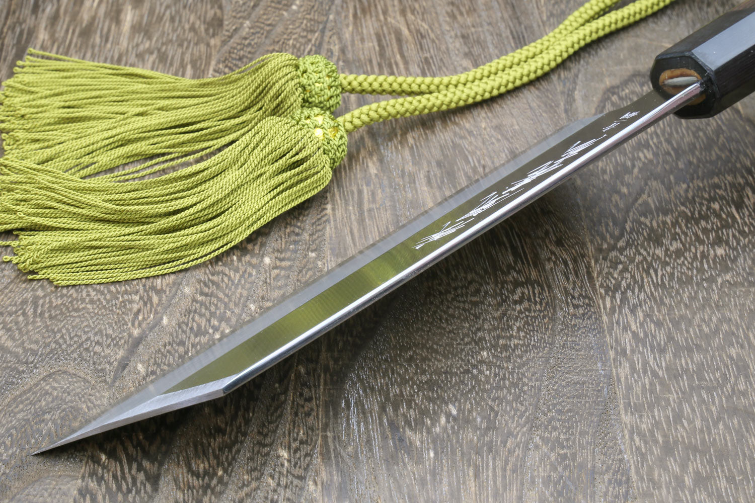 Japanese single-edged vegetable knife with green cord tassel and pointed silver blade