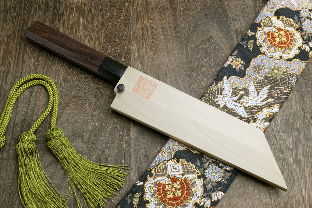 Japanese single-edged vegetable knife with wooden saya, green cords, and cloth wrap