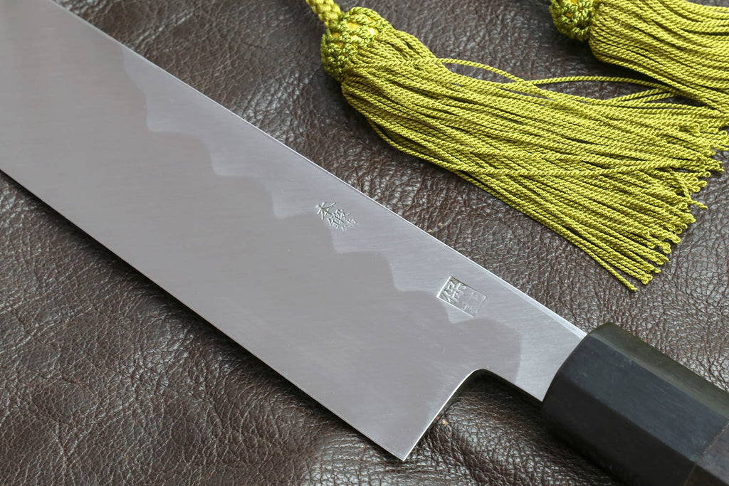 Multipurpose chef knife blade tip with etched text on silver steel