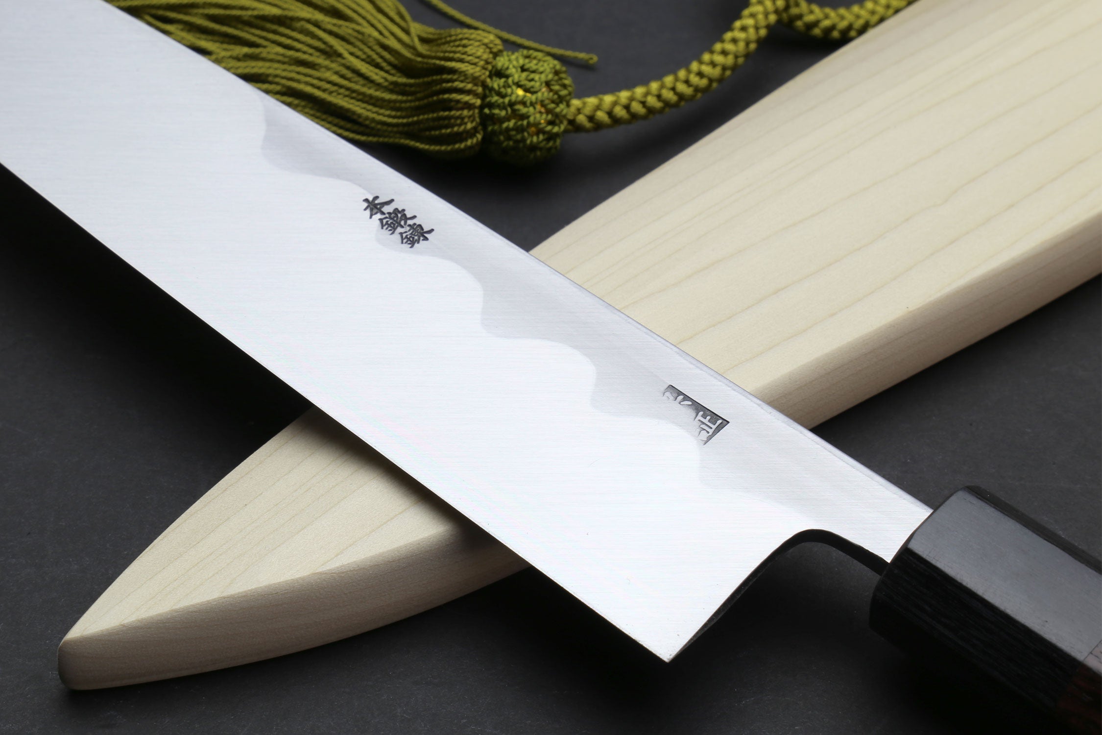 Japanese chef knife angled view with light saya and dark handle