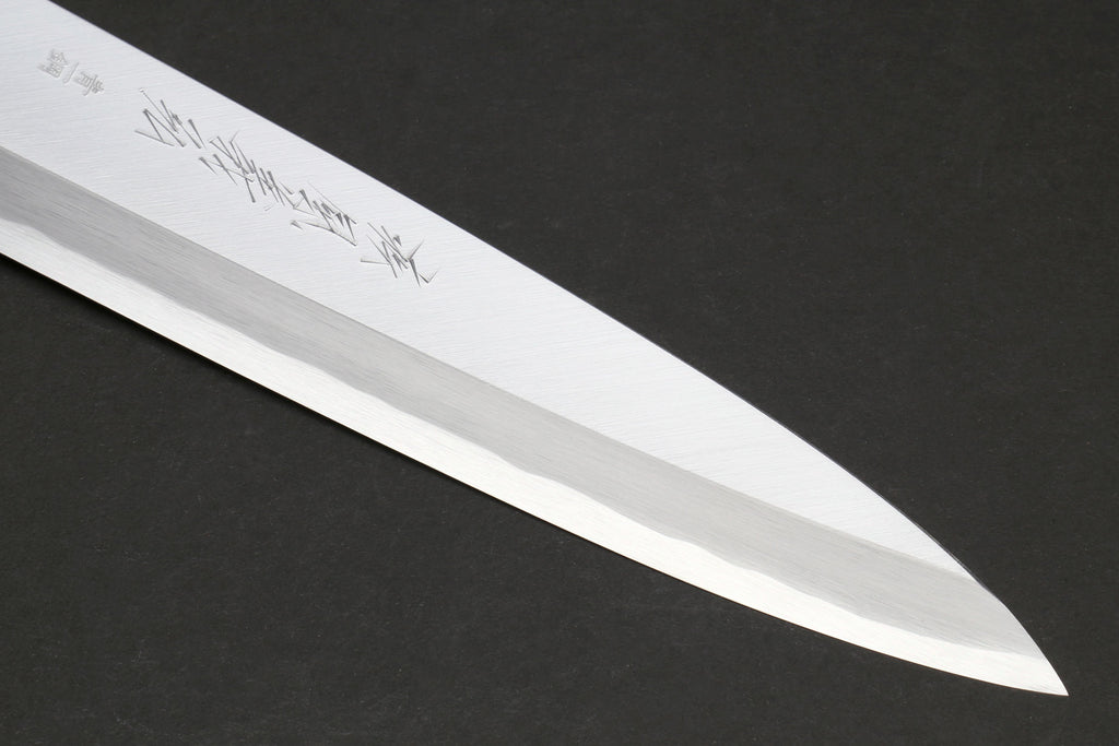 Japanese chef knife blade close-up with polished steel edge