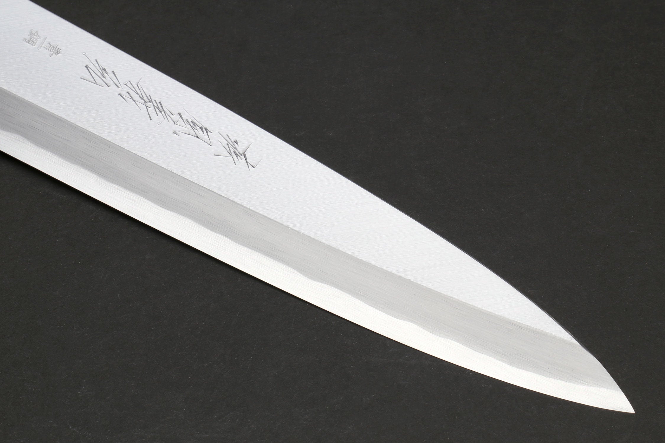 Japanese chef knife blade close-up with polished steel edge
