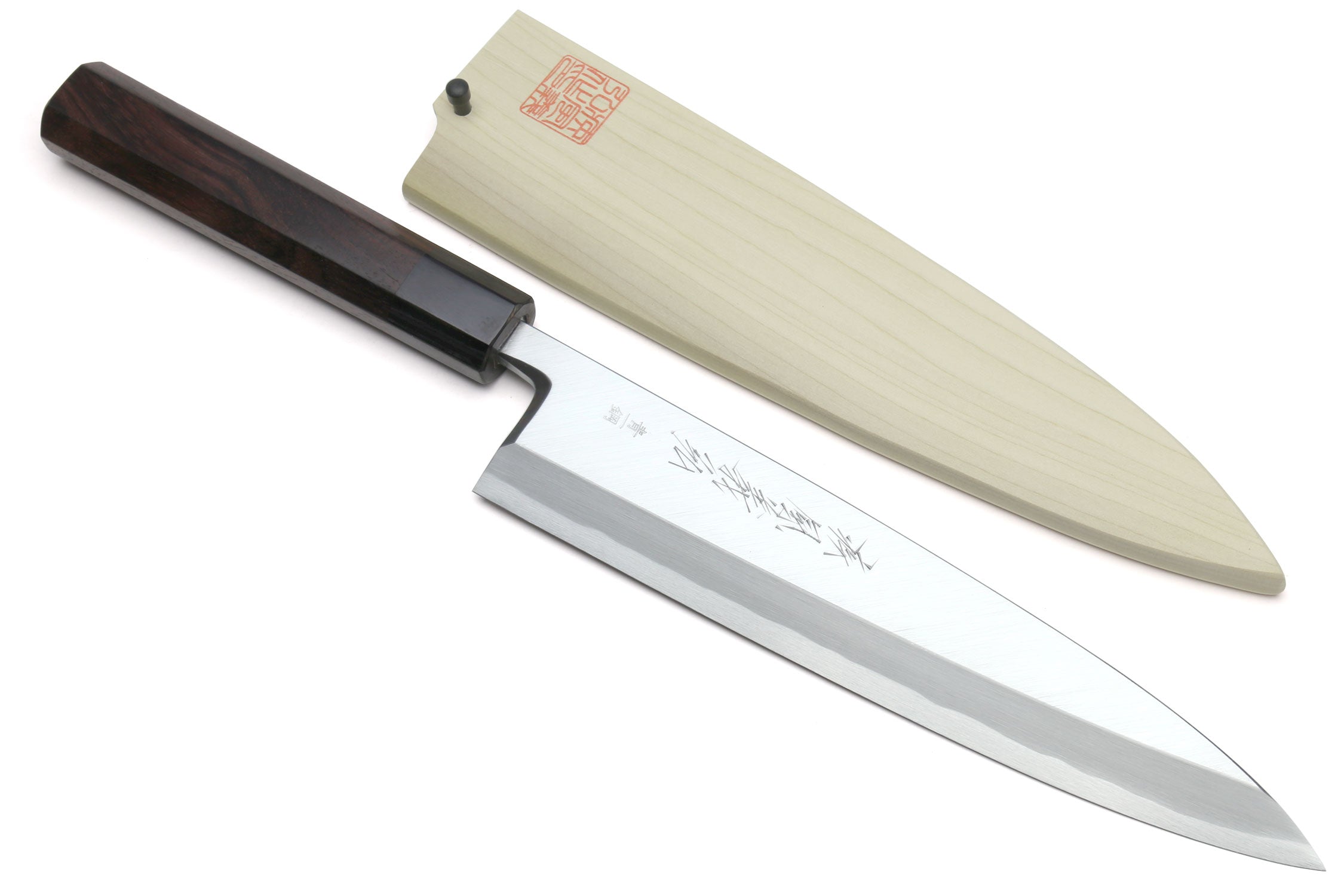 Two Japanese chef knives with light saya and dark handle blocks