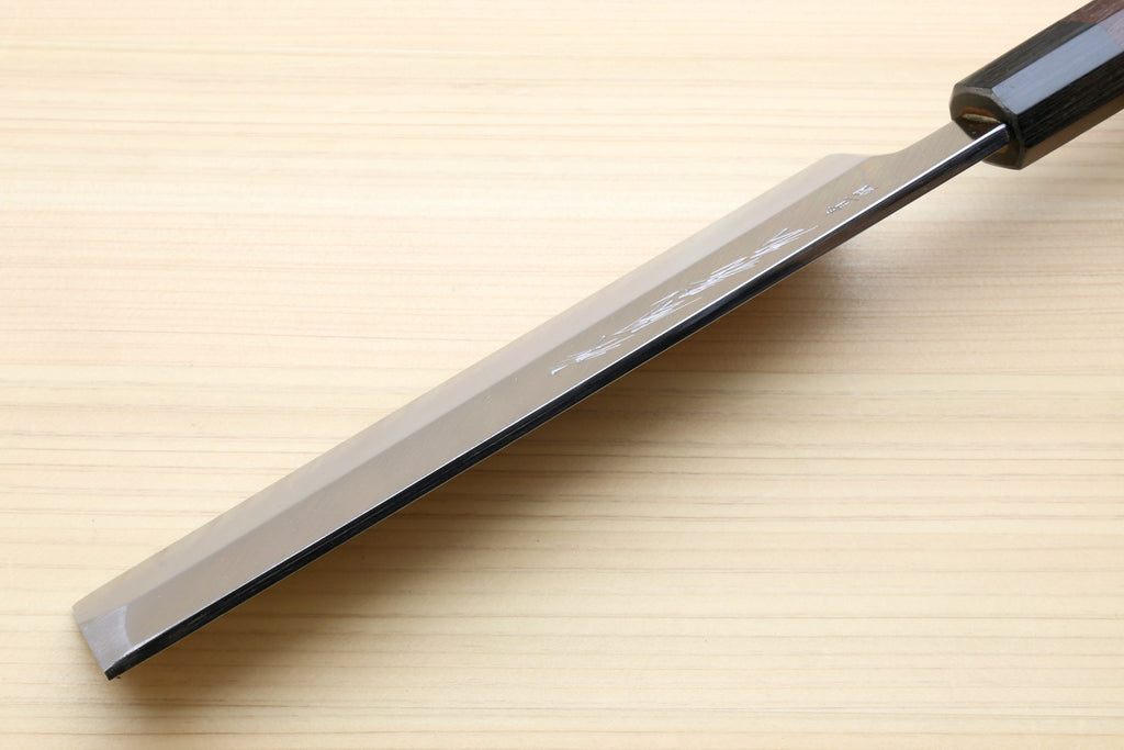 Japanese vegetable knife side view with pale steel blade and dark rosewood handle