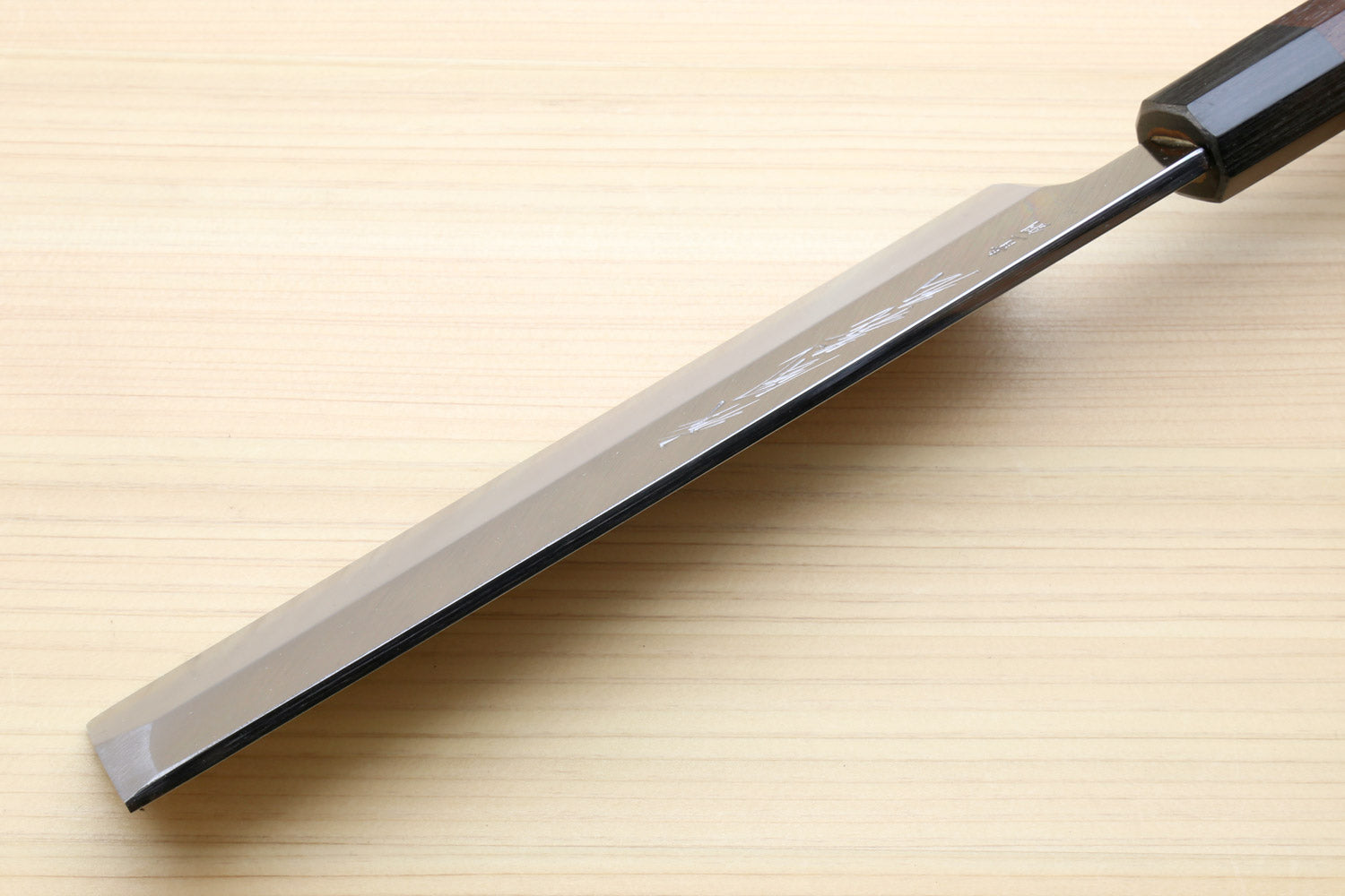 Japanese vegetable knife side view with pale steel blade and dark rosewood handle
