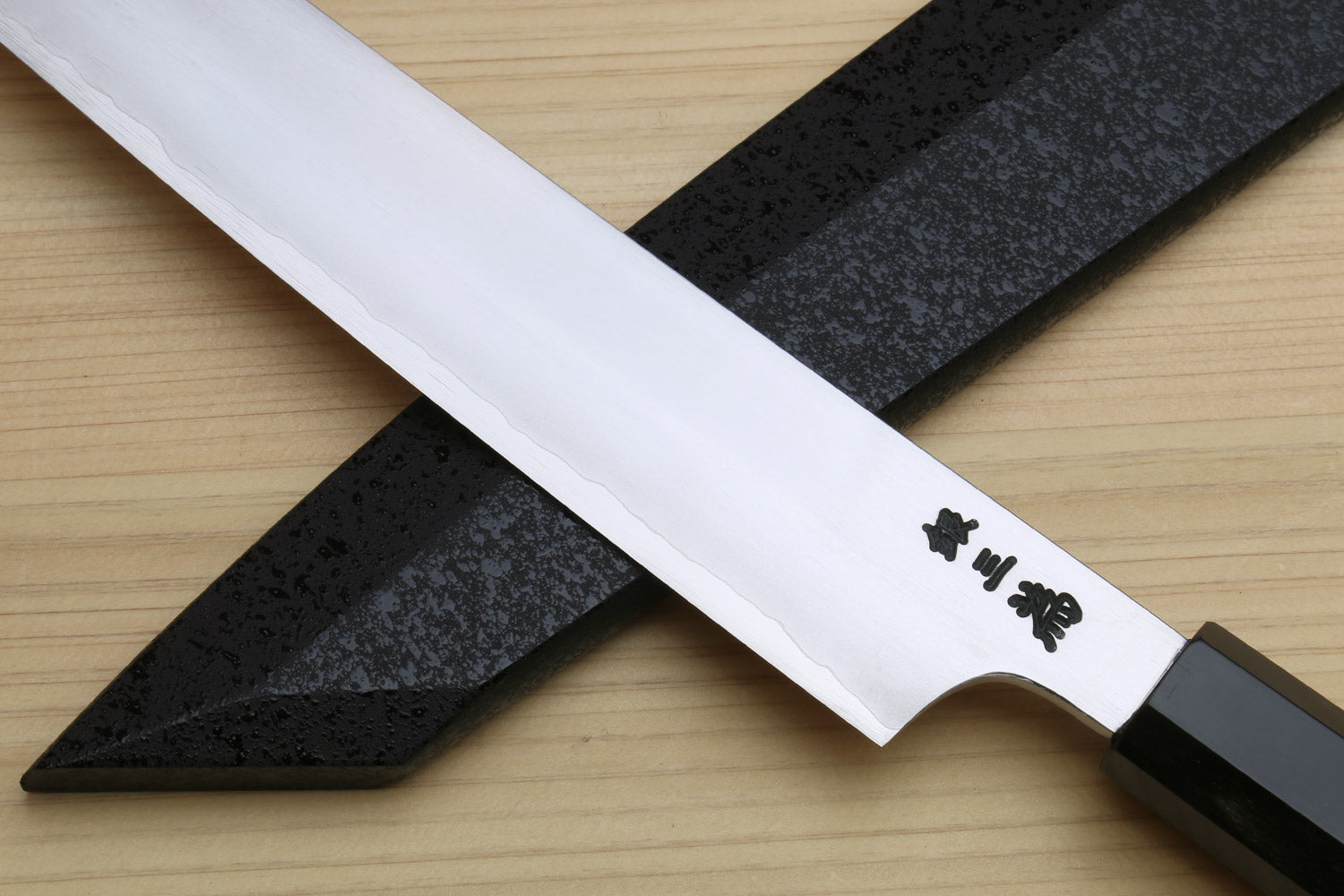 Kiritsuke slicer knife with white blade, engraved kanji, and dark ebony handle