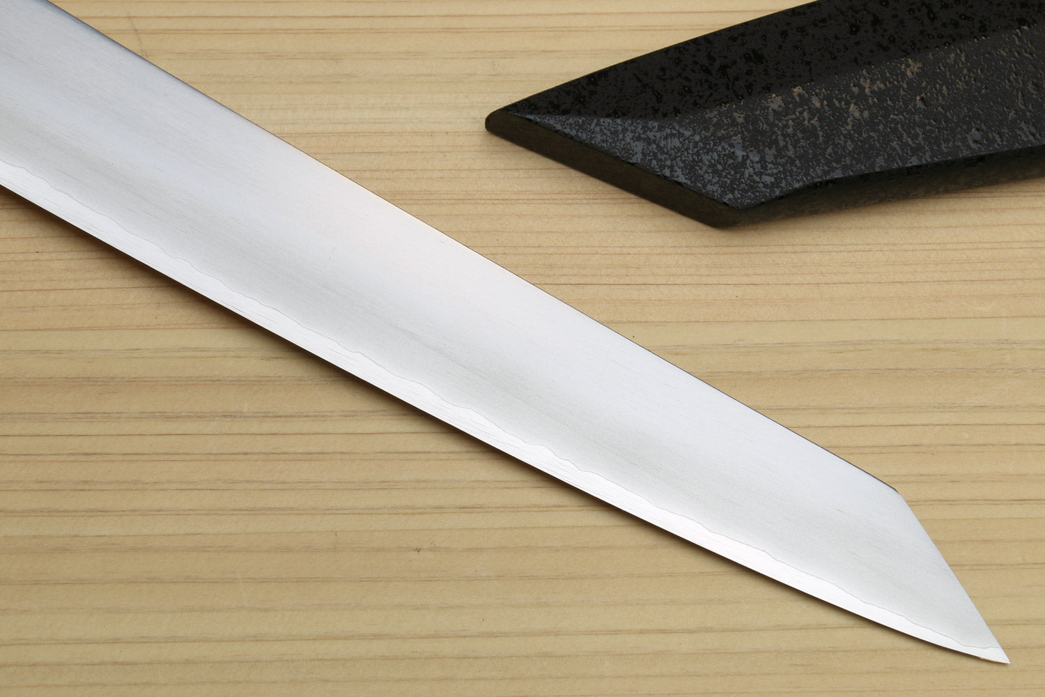 Kiritsuke slicer knife tip with white blade and smooth dark ebony handle