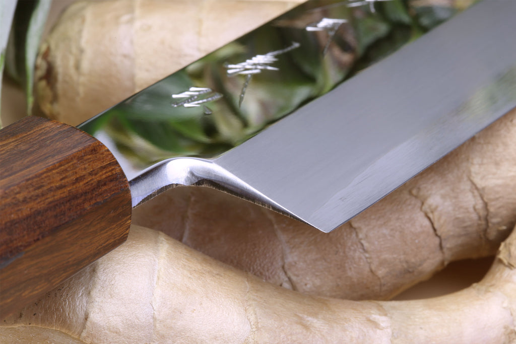 Ebony-handled Japanese vegetable knife with mirror-polished blade edge detail